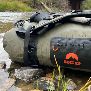 Fully waterproof duffel bag sitting in river